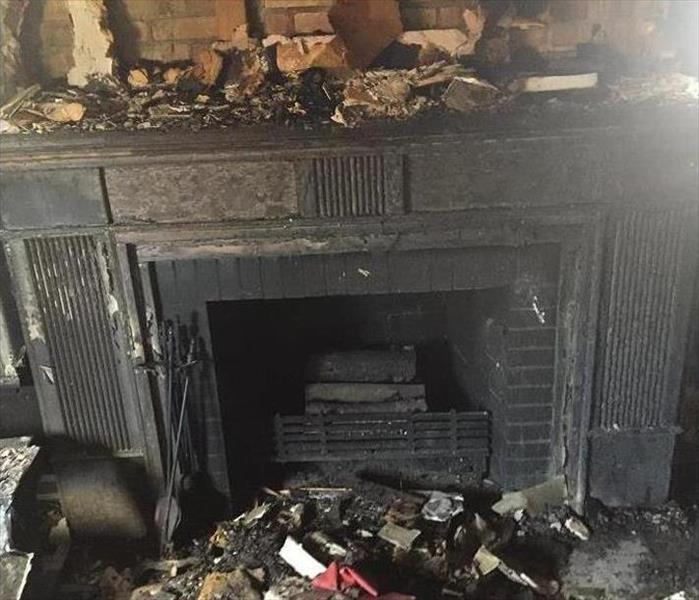 Charred and debris-filled fireplace 