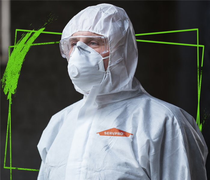 SERVPRO tech wearing white hooded hasmat protective suit.