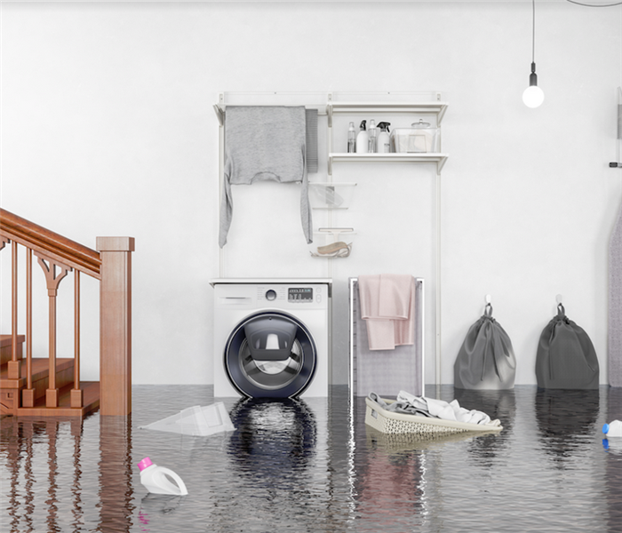 a flooded laundry room with items floating everywhere