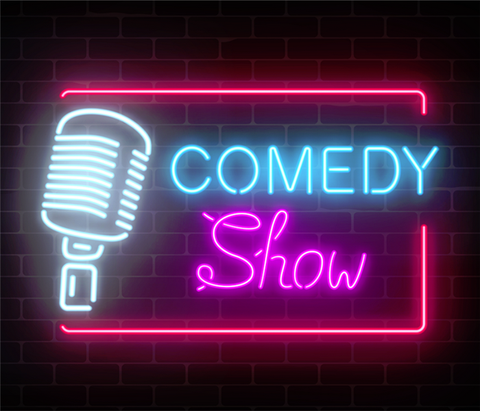 neon sign showing the words comedy show